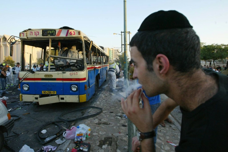 In this August 2004 file photo, an Israeli man looks at a bus destroyed in a suicide bombing, claimed by a Palestinian group, in a southern Israeli town