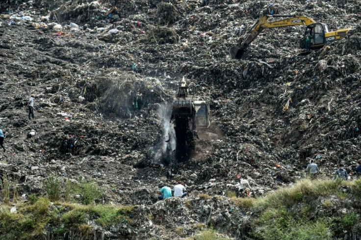 Rescuers searching the Pirana landfill in Ahmedabad for Neha Vasava, 12, who was buried while "rag picking" on the garbage dump