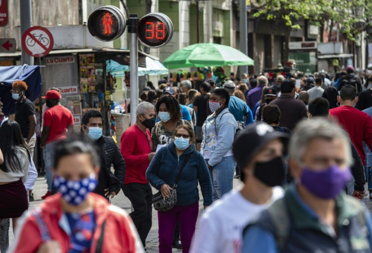 People walk along a pedestrian street in downtown Santiago as lockdown measures were lifted