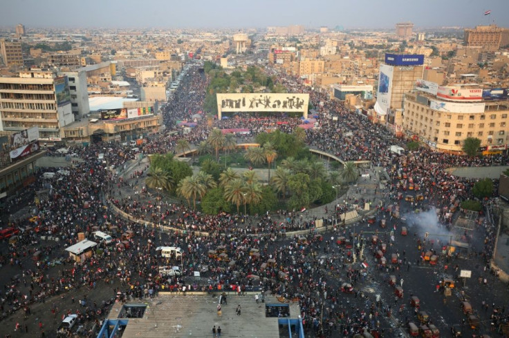 Iraqi demonstrators stand at Tahrir Square in Baghdad in October 2019 anti-government demonstrations