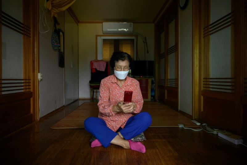 Sitting in her tiny home, 83-year-old Moon Haeng-ja is struggling to master a new skill as the pandemic plays havoc with South Korea's harvest celebrations: making video calls