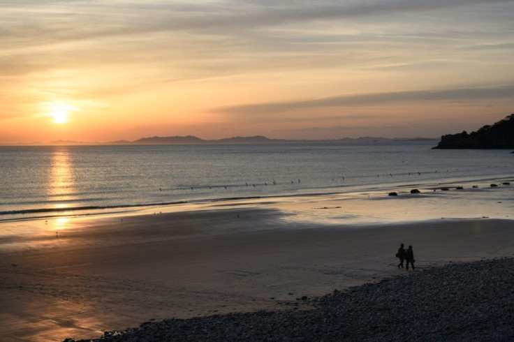 The sun sets over the coast of North Korea, seen from Yeonpyeong Island in South Korea