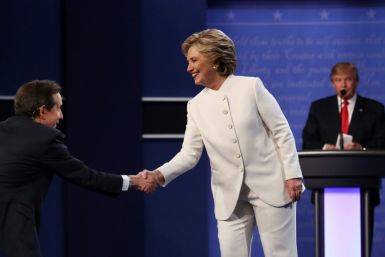 Fox News anchor Chris Wallace shakes hands with Democratic candidate Hillary Clinton at the start of her 2016 debate with Republican presidential nominee Donald Trump