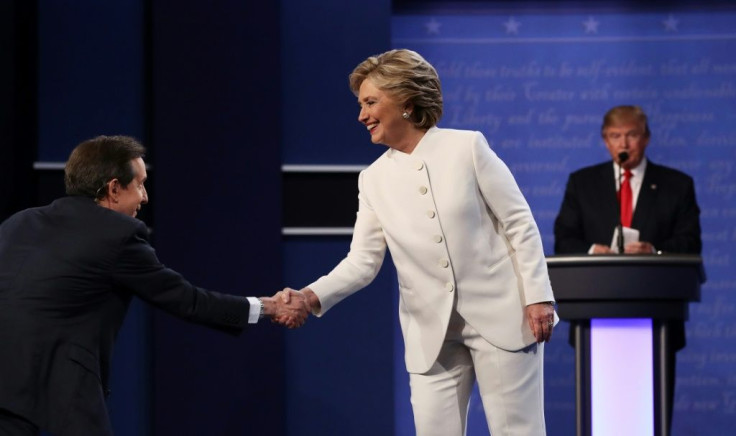 Fox News anchor Chris Wallace shakes hands with Democratic candidate Hillary Clinton at the start of her 2016 debate with Republican presidential nominee Donald Trump