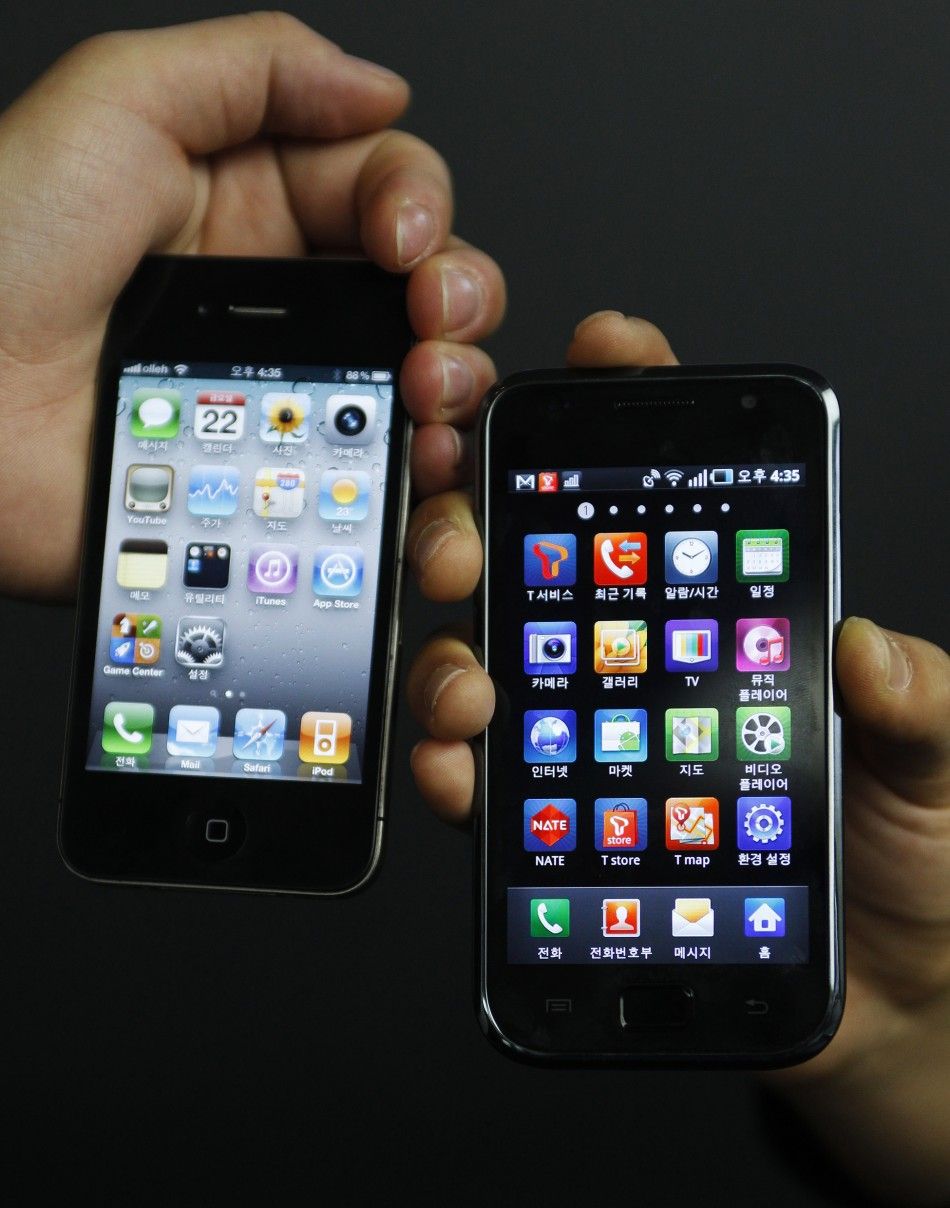 An Apple Incs iPhone 4 smartphone and a Samsung Electronics Galaxy S smartphone is seen in this picture illustration.