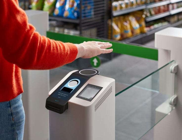 This undated handout photo courtesy of Amazon shows a person waving their hand above the new Amazon palm recognition payment system called "Amazon One" to be used in the company's retail locations