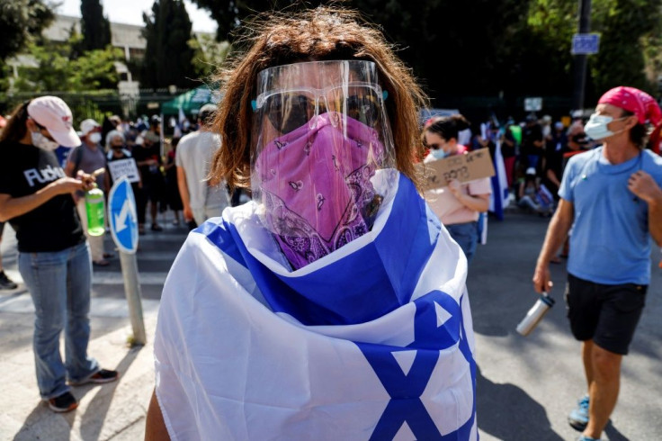 Israeli demonstrators, angry at the new government powers to restrict gatherings, protest outside parliament ahead of the vote