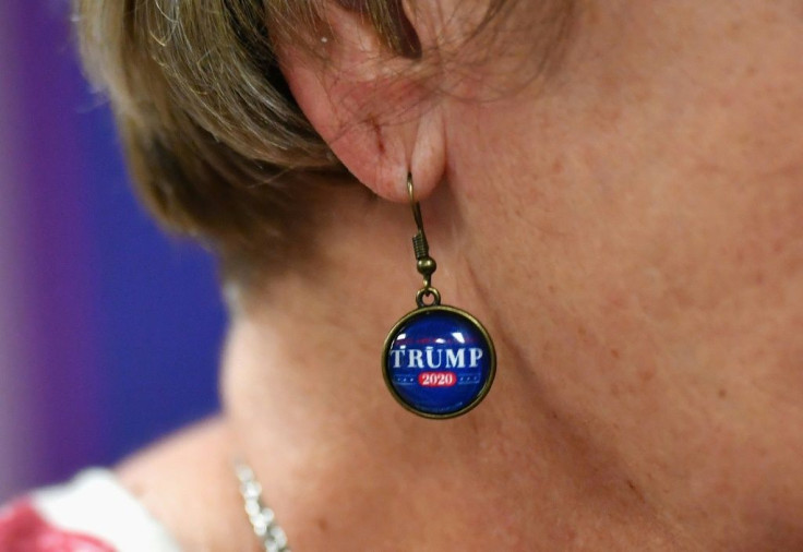 A Trump supporter models her earrings dedicated to the US president