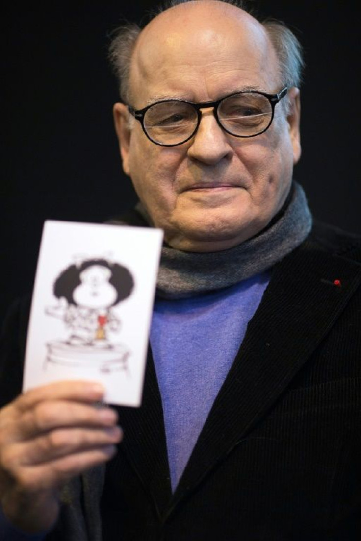 Argentinian cartoonist Quino, creator of the "Mafalda" comic strip, holds a drawing of his famous character at the Paris Book Fair in March 2014