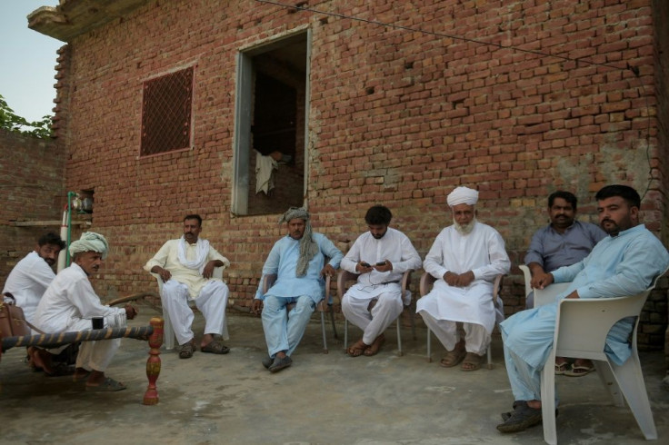 Arshad Mehmood (3rd from right) says neighbours came to his home to congratulate him after his son carried out a knife attack in Paris