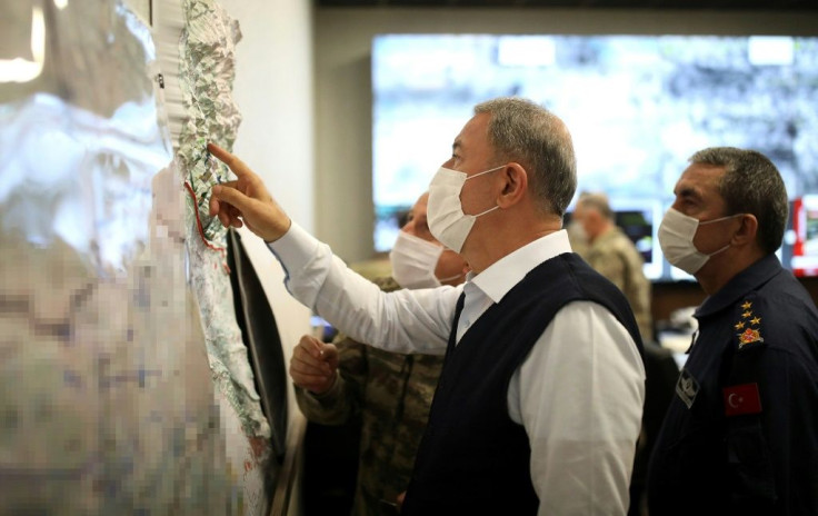 Turkish Defence Minister Hulusi Akar -- photographed in June 2020 -- studies a map at the start of Ankara's latest military operation against the PKK in Iraq