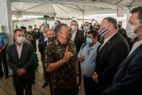 Secretary of State Mike Pompeo, wearing a mask, tours a processing center for Venezuelan migrants on a September 2020 visit to the Brazilian border town of Boa Vista