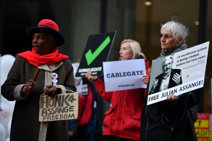 Protestors hold placards and shout slogans demanding  the release of WikiLeaks founder Julian Assange, who faces extradition to the United States, as they gather outside the Old Bailey in the City of London on October 1, 2020