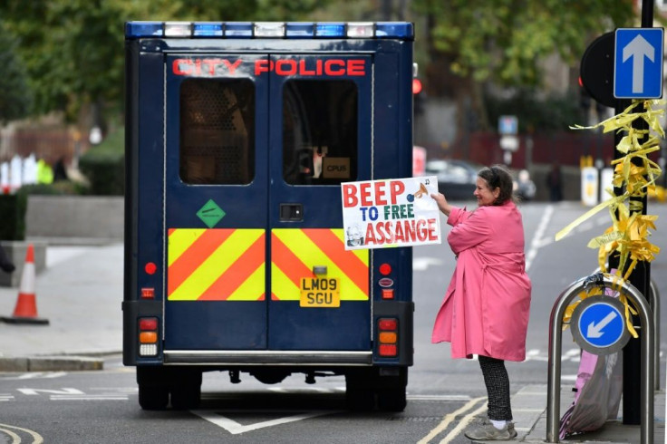 A protestor holds a placard demanding the release of WikiLeaks founder Julian Assange, who faces extradition to the United States, outside the Old Bailey in the City of London on October 1, 2020