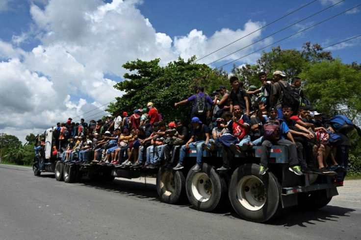 Honduran migrants, part of a caravan heading to the US, seen on board a truck in Entre Rios, Guatemala