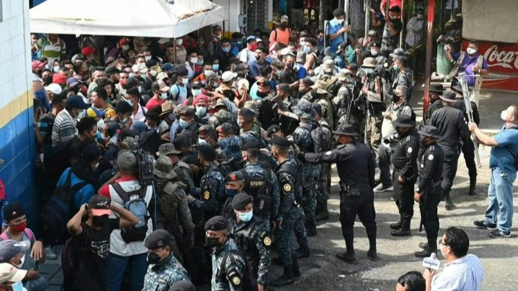 Honduran migrants break past a line of police officers and enter Guatemala as they pursue their trek to the United States in the hope of finding a better quality of life and escaping violence and poverty back home.