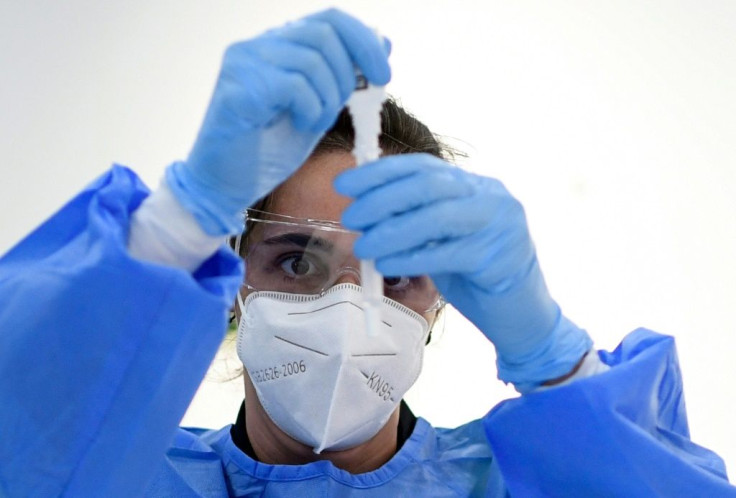 A medical worker runs a rapid Covid-19 test at the Lope de Vega Cultural Center in the Vallecas neighbourhood, in Madrid