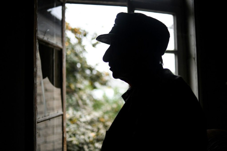 Mavrik Grigoryan, 72, stands inside his house damaged by shelling during fighting between Armenia and Azerbaijan over the breakaway Nagorny Karabakh region, in the disputed region's city of Martuni