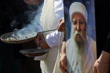 Iraqi Yazidis burn incense at the funeral of their revered spiritual leader Baba Sheikh Khurto Hajji Ismail