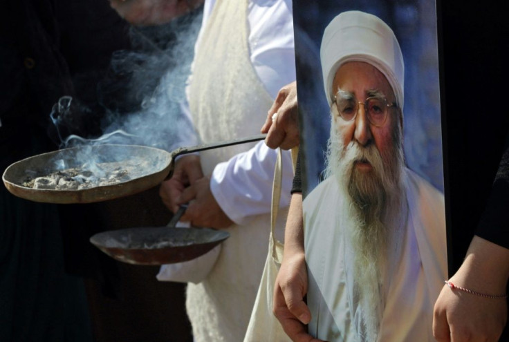 Iraqi Yazidis burn incense at the funeral of their revered spiritual leader Baba Sheikh Khurto Hajji Ismail