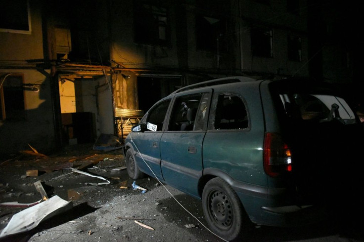 A car with broken windows is seen in front of an apartment building that was damaged by recent shelling in the breakaway Nagorno-Karabakh region's main city of Stepanakert on October 2, 2020, during the ongoing fighting between Armenia and Azerbaijan over