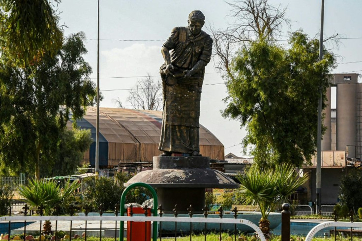 The statue 'The Licorice Man' depicts a street peddler selling juice and candy made from the plant