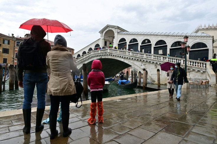 People view the Rialto bridge in Venice to watch an expected high tide "Alta Acqua" phenomenon