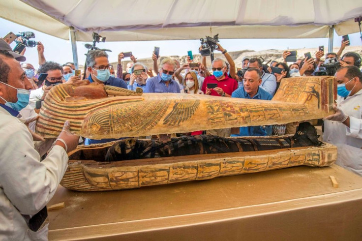 Egypt's tourism and antiquities minister, Khaled al-Anani (L), and Mostafa Waziri (R), secretary general of the Supreme Council of Antiquities, open a sarcophagus excavated at the Saqqara necropolis
