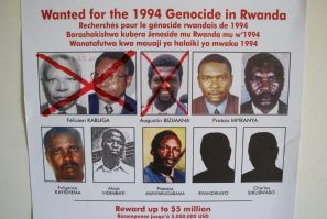 A picture taken on May 19, 2020, shows key suspects in the 1994 Rwandan genocide, on a wanted poster on the wall at the Genocide Fugitive Tracking Unit office in Kigali, Rwanda