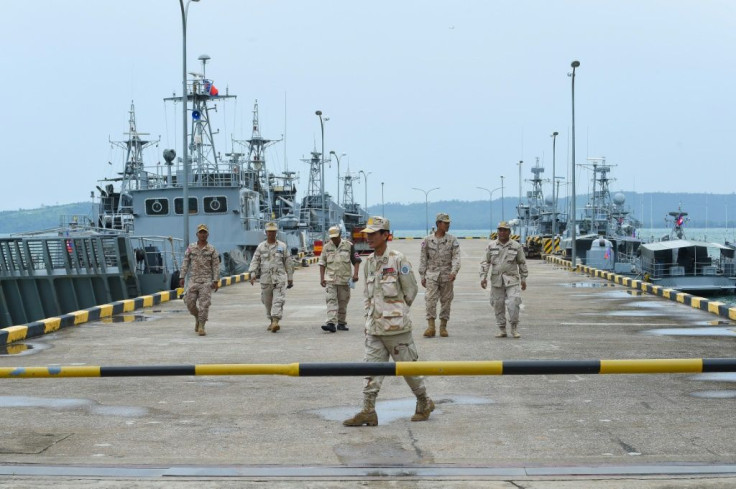 Cambodian navy personnel walk on a jetty at the Ream naval base during a government-organised media tour in July, 2019