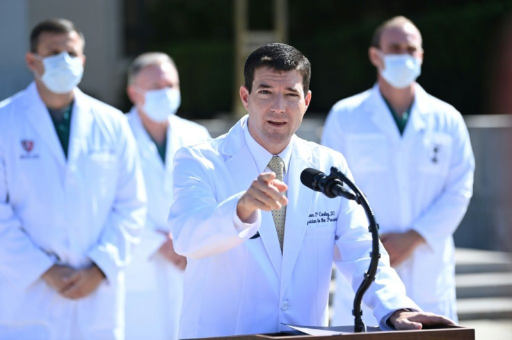 White House physician Sean Conley answers questions surrounded by other doctors, during an update on the condition of US President Donald Trump, on October 4, 2020, at Walter Reed Medical Center in Bethesda, Maryland
