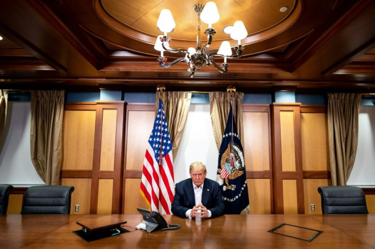 His Covid-19 diagnosis has left President Donald Trump (pictured in his conference room at Walter Reed Medical Center) sidelined from campaiging just a month before the November 3 election
