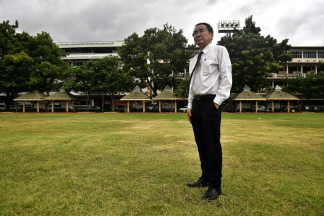 Lawyer Krisadang Nutcharut stands in the football field, where his fellow students were killed during the Thammasat University massacre 40 years ago