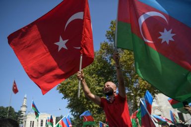 An Azeri protester waves Azerbaijani and Turkish national flags in a demonstration in Istanbul on Sunday