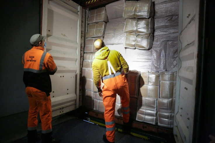 Dock workers open the back of a lorry at the customs to verify its load, at the port of Antwerp. Grenade explosions, shootings and even kidnapping of children: drug trafficking is generating a violent crime wave