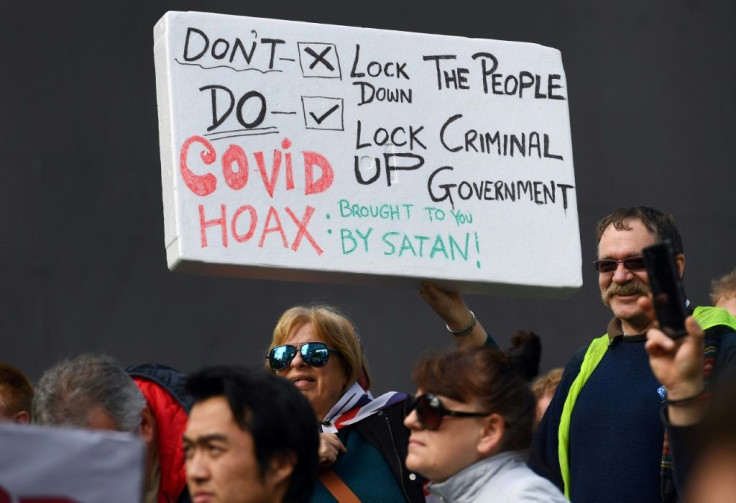 QAnon-related conspiracy theories have been seen at protests in many cities recently, including Melbourne