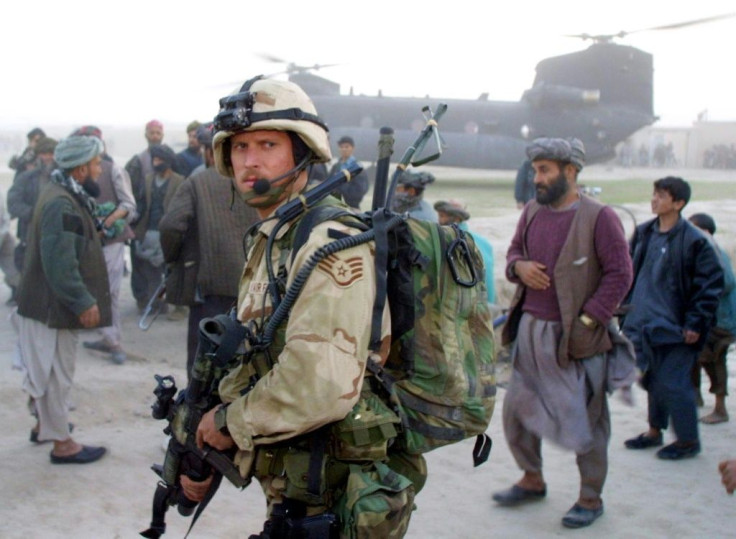 A US Air Force Special Operations soldier stands guard near a Chinook in Kwaja Bahuddine on November 15, 2001. Nearly two decades on, many Afghans fear the return of the Taliban
