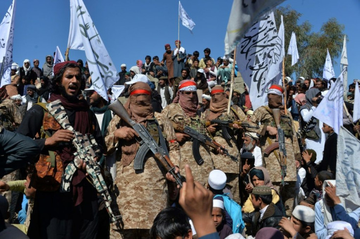 Afghan Taliban militants and villagers in Laghman province celebrate on March 2, 2020 after the peace deal with the United States