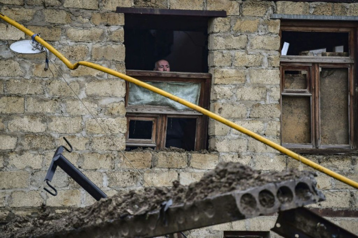 An elderly man looks out from a building damaged by an explosion in the breakaway Nagorno-Karabakh region's main city of Stepanakert