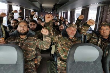 Volunteers and reservists ride a bus towards the Karabakh frontline