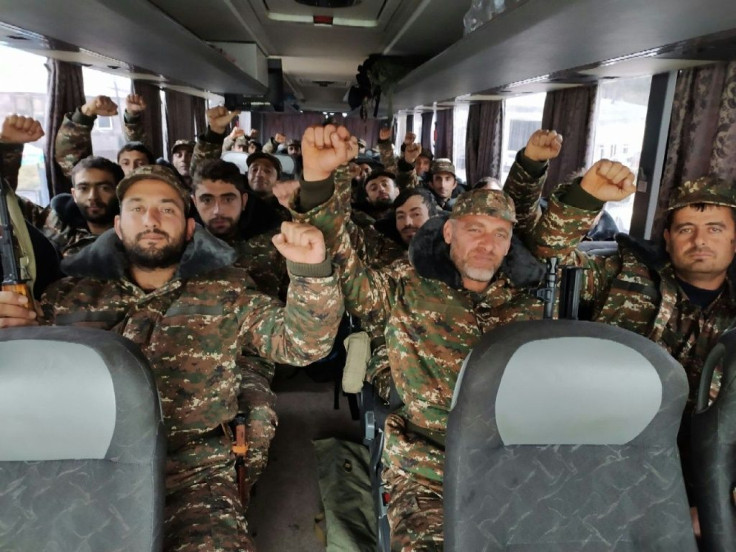 Volunteers and reservists ride a bus towards the Karabakh frontline