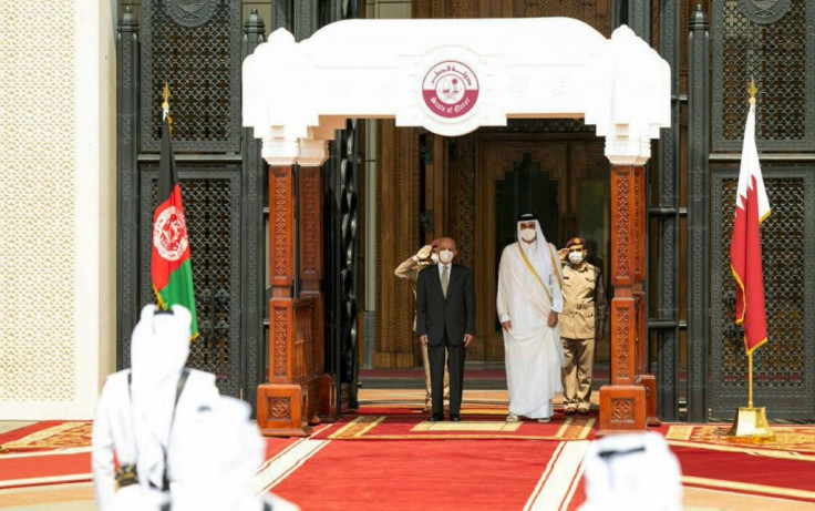 Qatar's ruler Emir Sheikh Tamim bin Hamad Al-Thani welcomes Afghan President Ashraf Ghani ahead of their meeting in the capital Doha