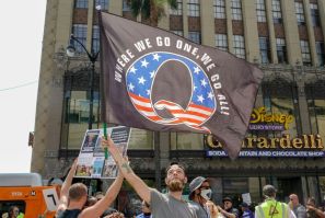 This file photo taken on August 22, 2020 shows demonstrators from conspiracy theorist group QAnon , as group which claims without evidence, that the pandemic is a conspiracy by a cabal of satanist paedophiles who control the world