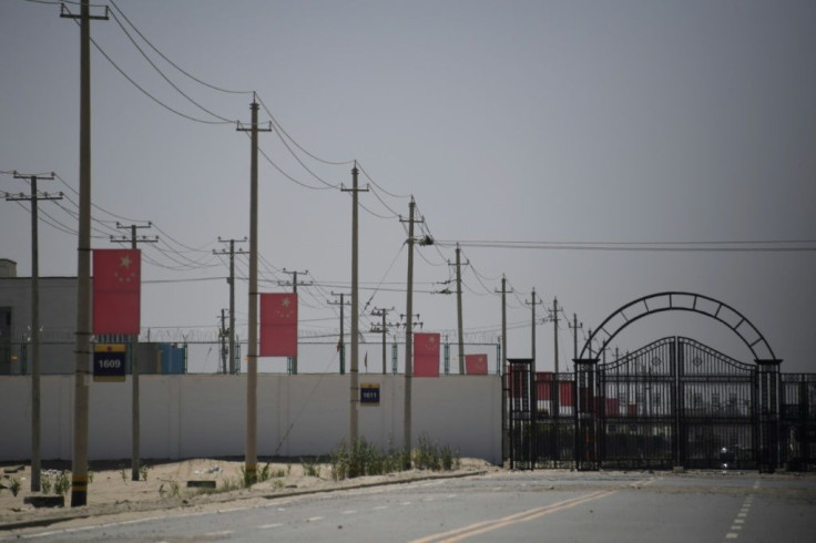 Chinese flags are seen along a road leading to a facility believed to be a re-education camp where mostly Muslim ethnic minorities are detained, on the outskirts of Hotan in the country's Xinjiang region in May 2019
