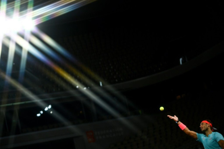 Let there be light: Rafael Nadal serves to Jannik Sinner