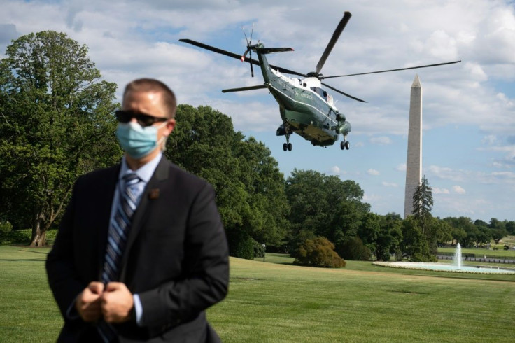 A US Secret Service agent stands by as Marine One, with US President Donald Trump aboard, departs from the South Lawn of the White House