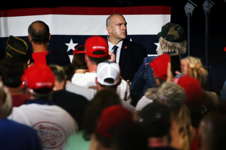 A mask-less Secret Service agent keeps watch as President Donald Trump speaks at a New Hampshire campaign rally in August despite the coronavirus pandemic