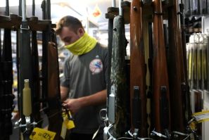 A customer looks at guns at Coliseum Gun Traders Ltd. in Uniondale, New York
