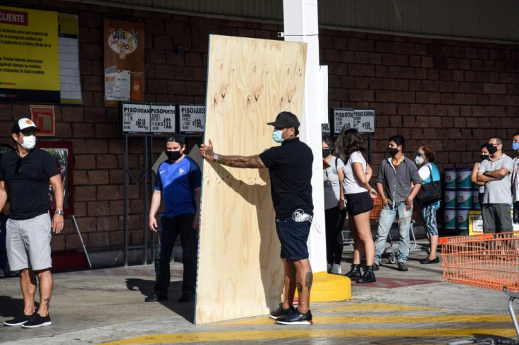 Cancun residents buy boards to protect their homes as Hurricane Delta barrels towards southeast Mexico