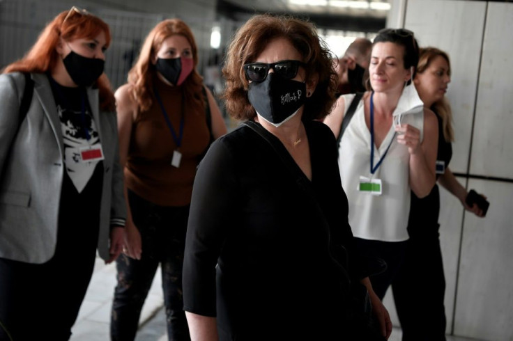 The mother of murdered rapper Pavlos Fyssas arrives at court in Athens ahead of the verdict in the trial of suspected members of neo-Nazi party Golden Dawn